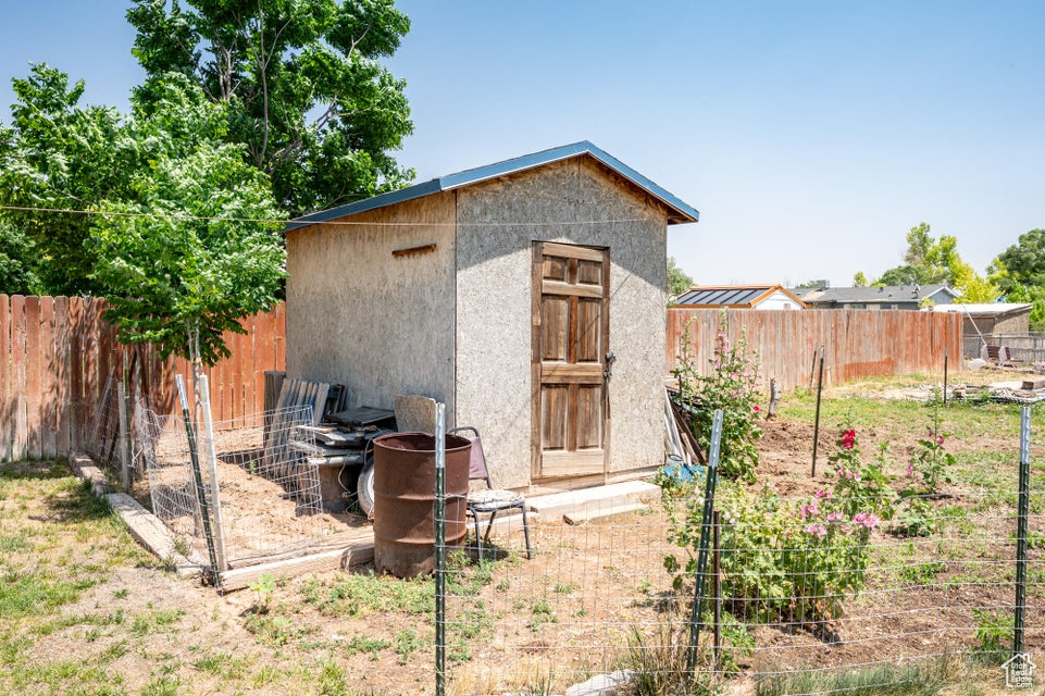 View of shed with a fenced backyard