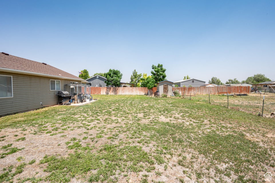 Fenced backyard with a shed
