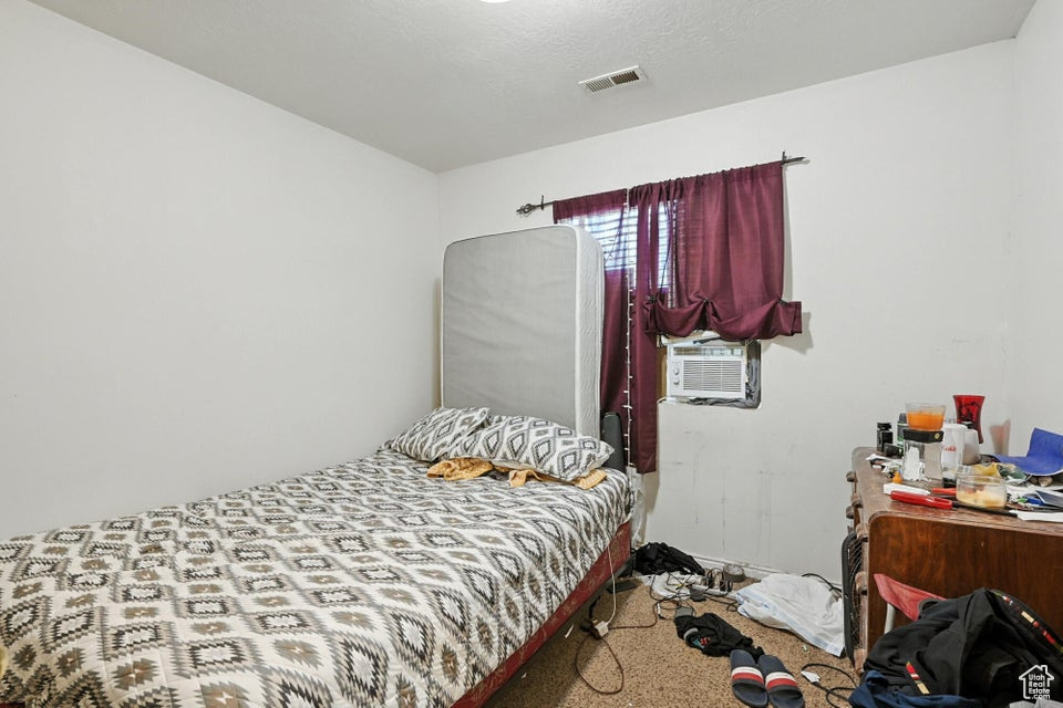 Carpeted bedroom with cooling unit