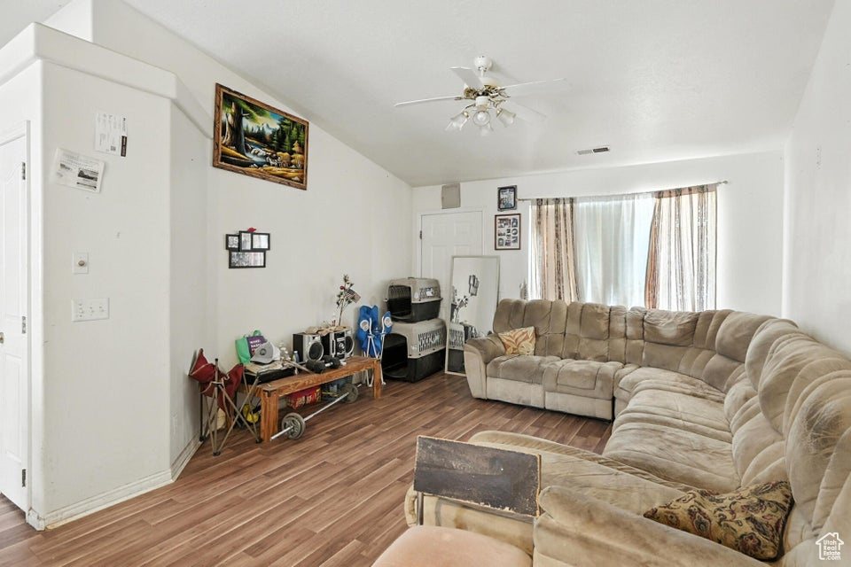 Living area with a ceiling fan and wood finished floors
