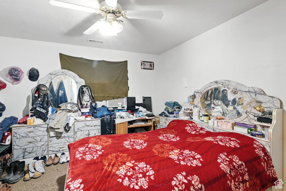 Bedroom with a ceiling fan and carpet flooring
