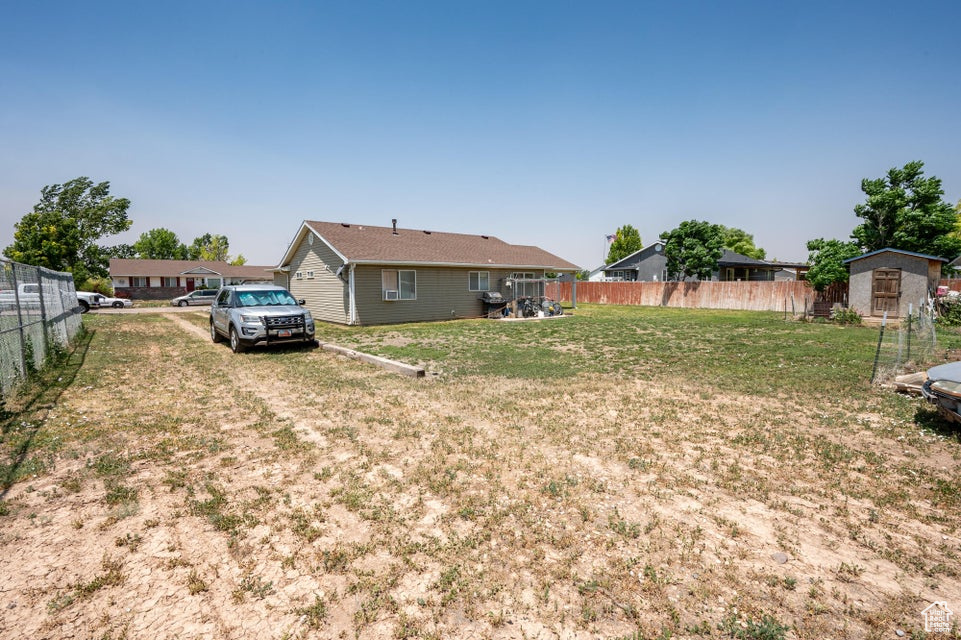View of yard featuring a storage unit