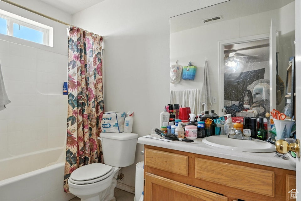 Full bath with vanity and shower / bath combination with curtain