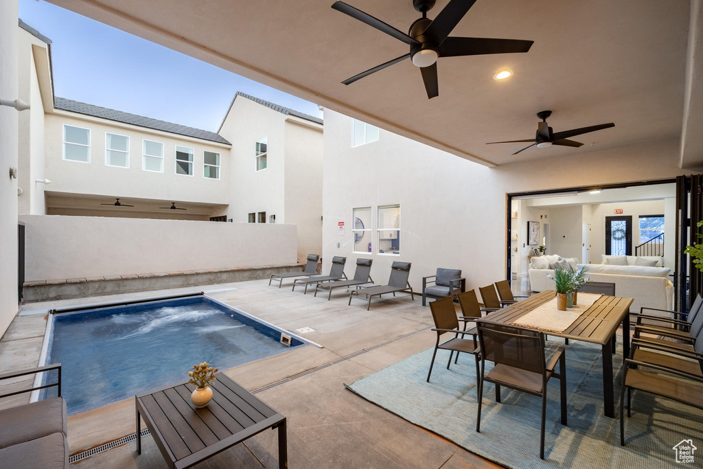 Swimming pool with ceiling fan, an outdoor hangout area, a patio area, and outdoor dining area