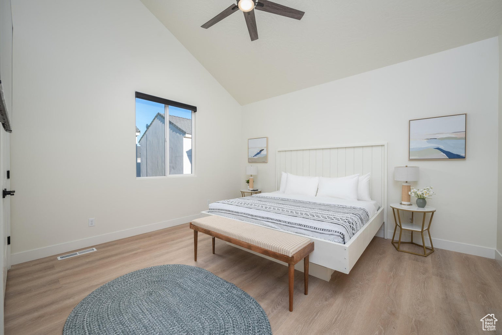 Bedroom featuring wood finished floors, high vaulted ceiling, and ceiling fan