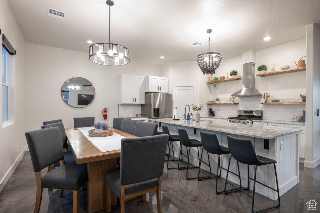 Dining room featuring a chandelier and recessed lighting