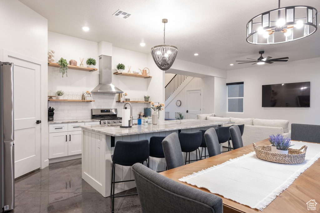 Dining room with a chandelier, recessed lighting, and a ceiling fan