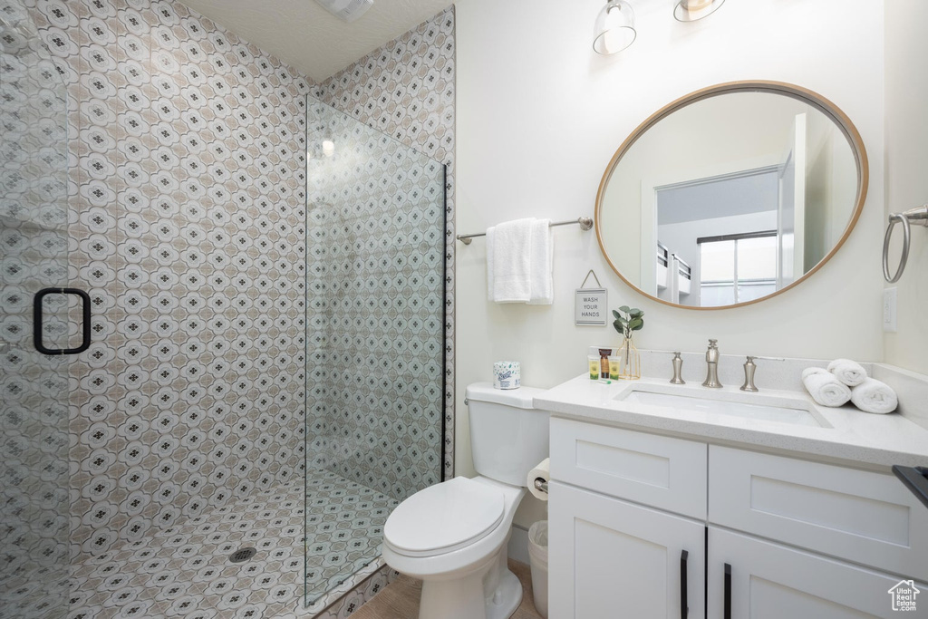 Bathroom featuring vanity and a tile shower