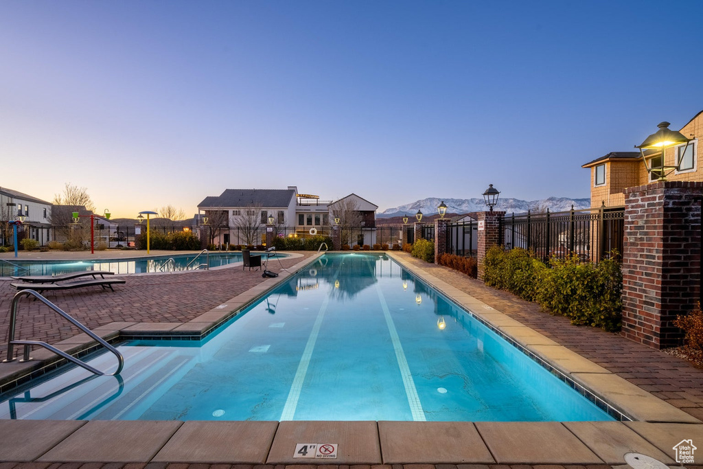 Community pool featuring a mountain view and a patio area