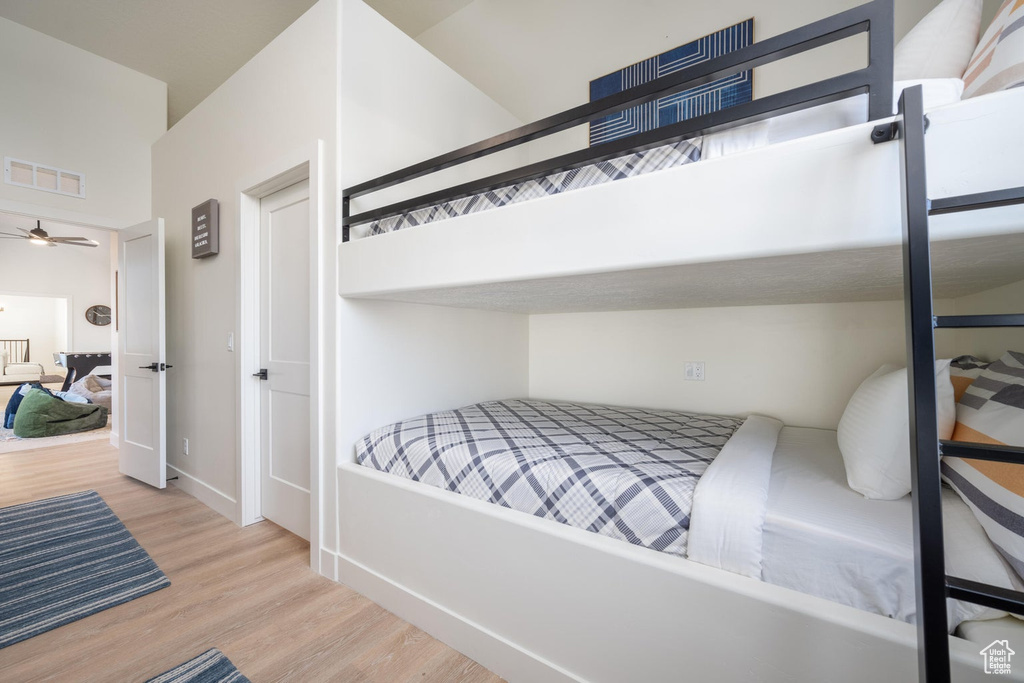 Bedroom with wood finished floors and baseboards