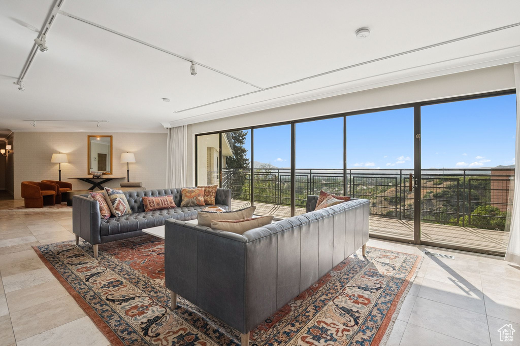 Living area featuring rail lighting and tile patterned flooring