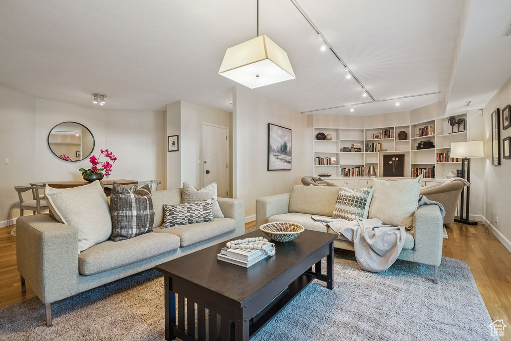 Living area featuring wood finished floors and rail lighting