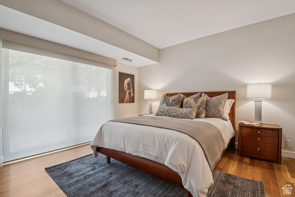 Bedroom featuring wood finished floors and baseboards