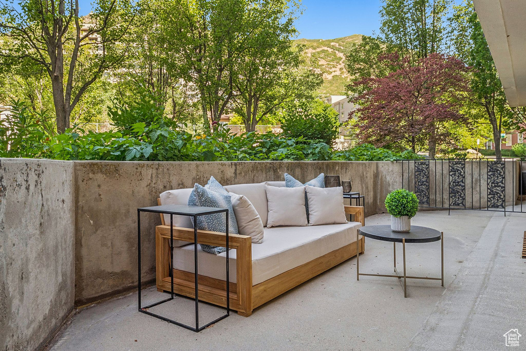 View of patio with an outdoor living space and a mountain view