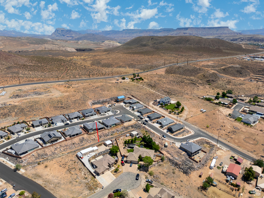 Aerial view of property's location featuring mountains and nearby suburban area