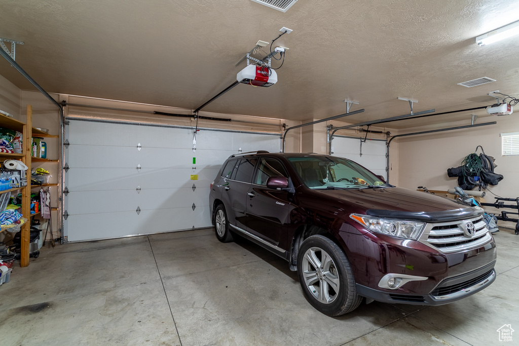 Garage featuring a garage door opener