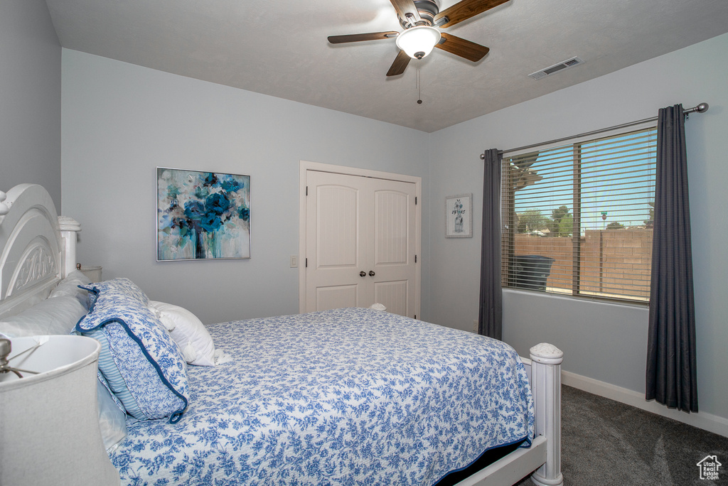 Bedroom with carpet flooring, ceiling fan, and a closet