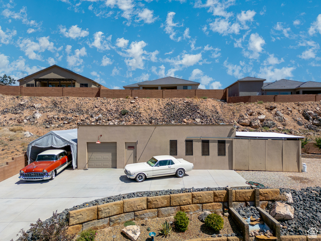 View of front of property with driveway and stucco siding