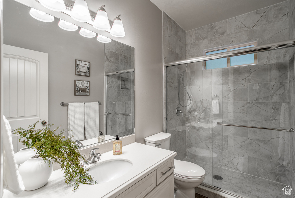 Bathroom featuring vanity and a stall shower