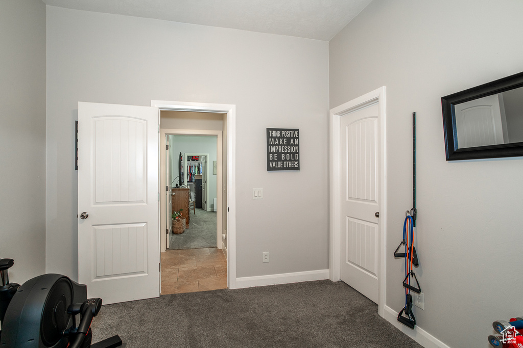Exercise room featuring carpet and baseboards