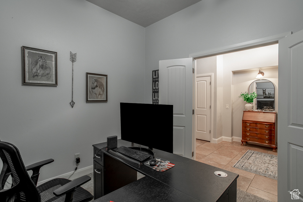 Office area featuring light tile patterned floors and baseboards