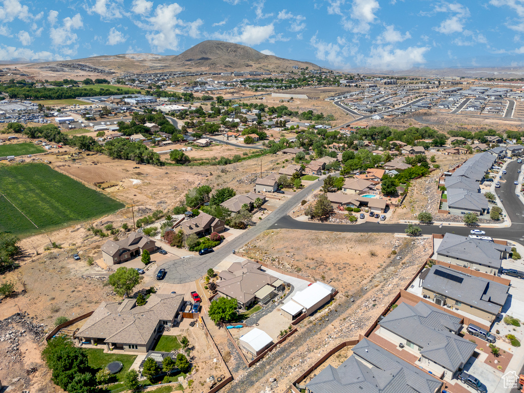 Aerial view of property's location featuring a mountain backdrop and nearby suburban area