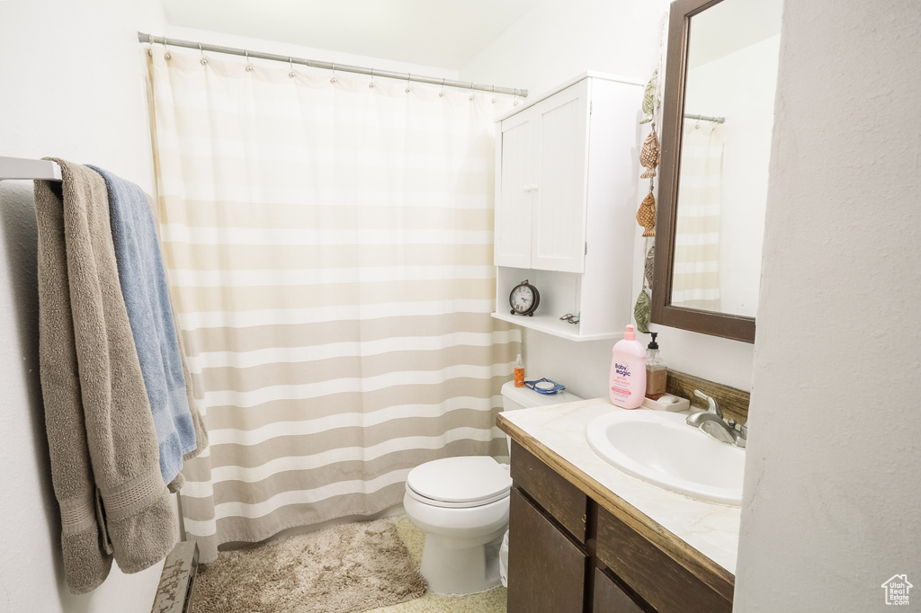 Bathroom featuring vanity and curtained shower