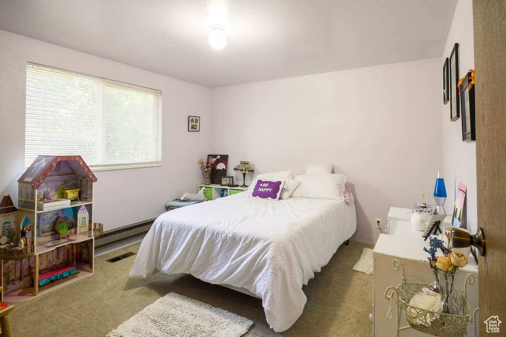 Carpeted bedroom with baseboard heating