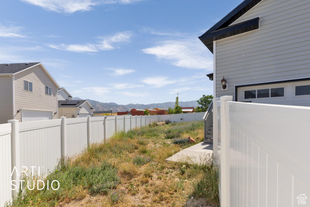 View of yard featuring a mountain view and a garage