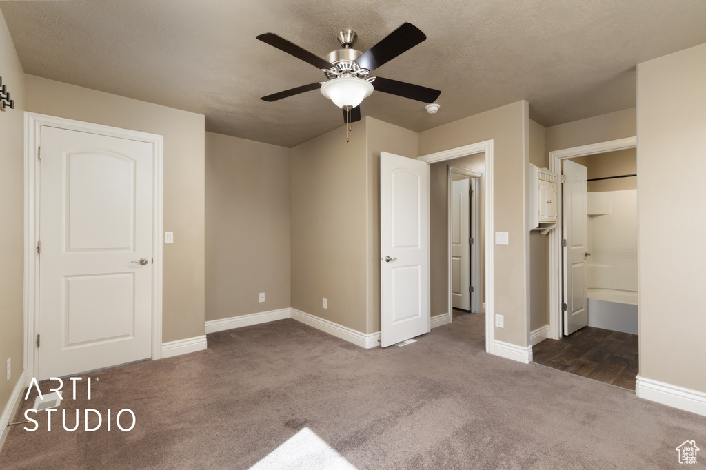 Unfurnished bedroom featuring carpet flooring and ceiling fan