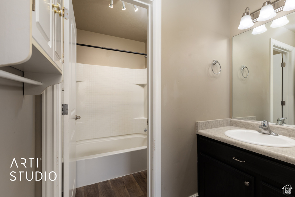 Full bathroom featuring vanity, wood finished floors, and bathing tub / shower combination