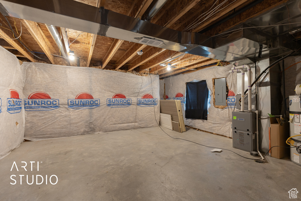 Unfinished basement with electric panel and heating unit