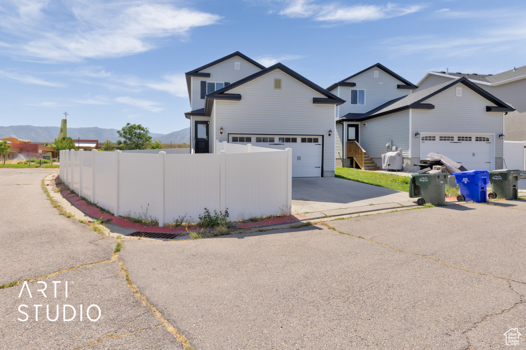 Traditional home featuring a mountain view and driveway