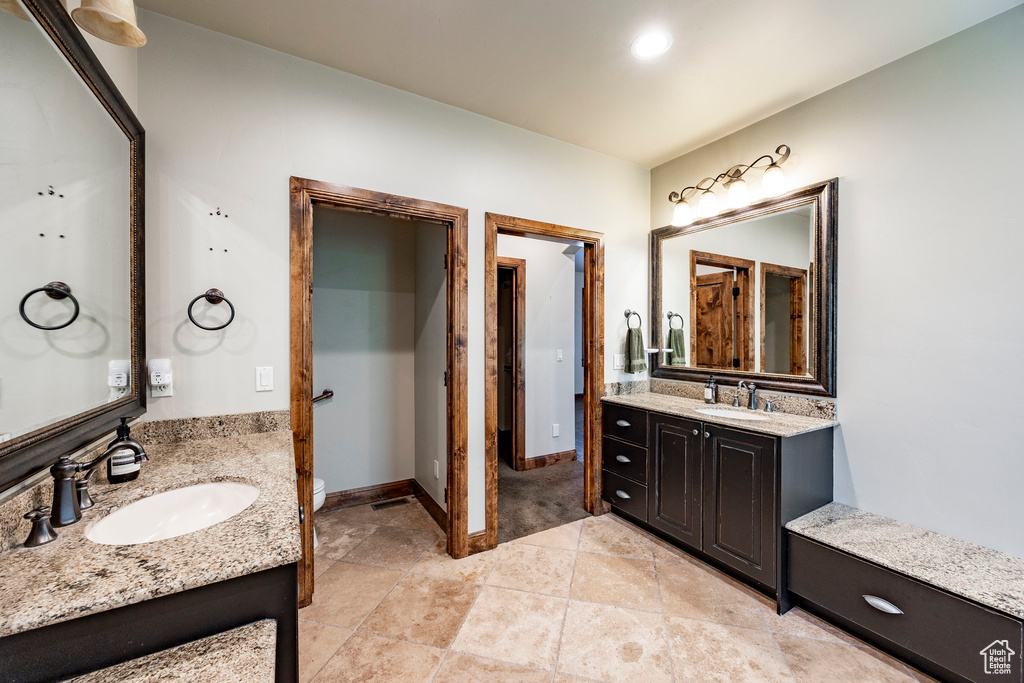 Full bath with two vanities and toilet