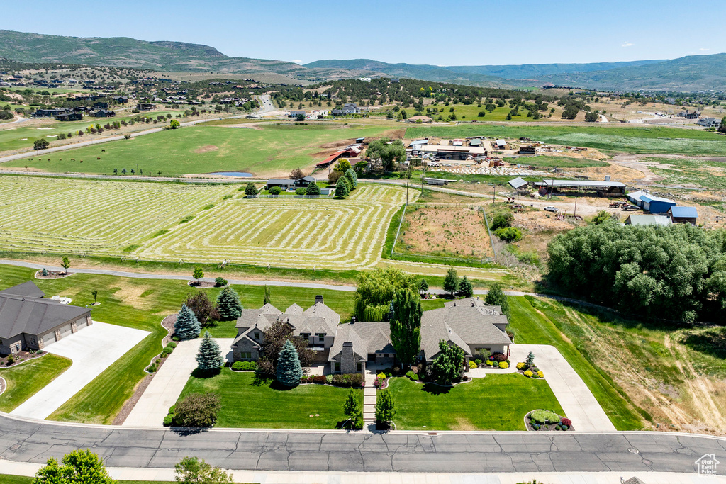Overview of rural landscape featuring a mountain backdrop and farmland