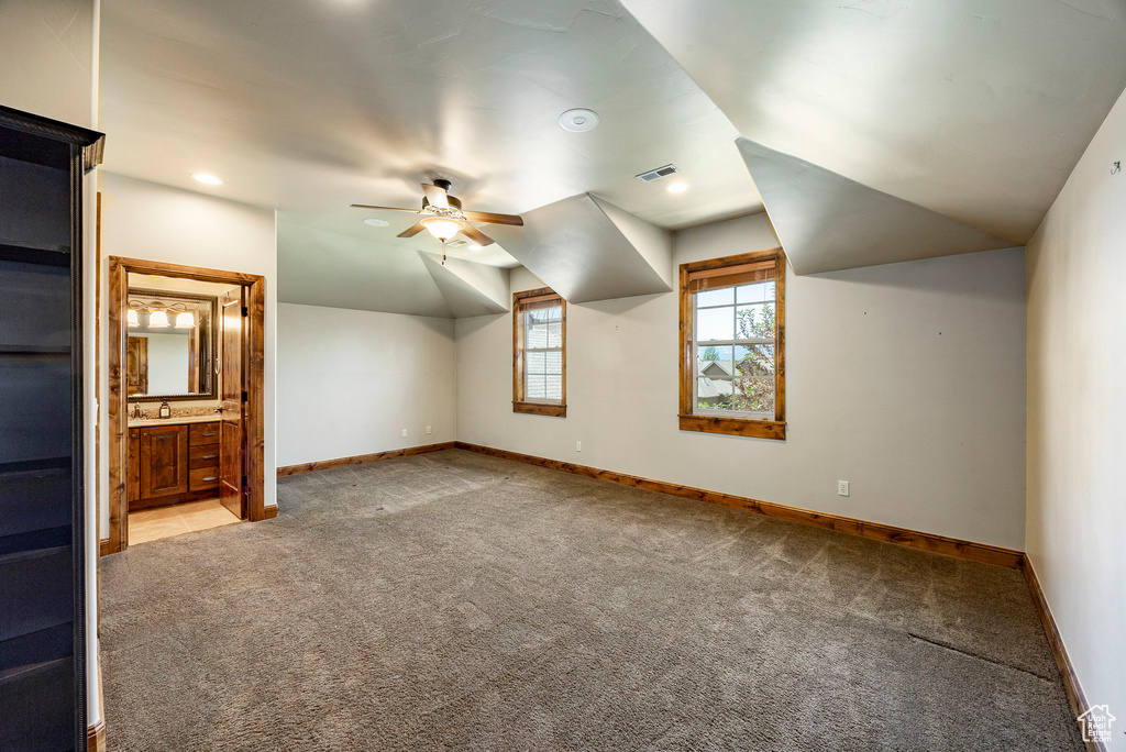 Additional living space featuring carpet, ceiling fan, vaulted ceiling, and recessed lighting