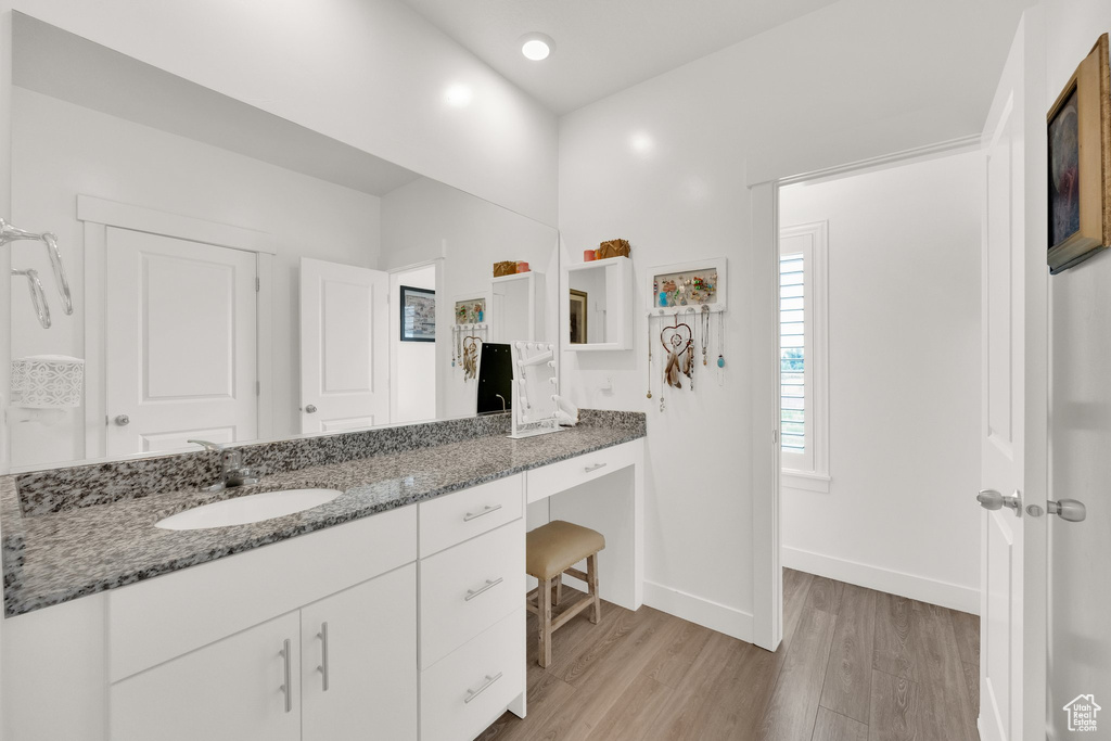 Bathroom featuring wood finished floors and vanity