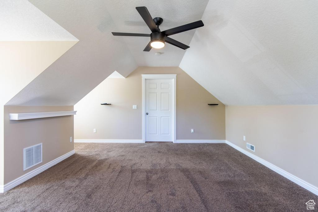 Bonus room with carpet, a ceiling fan, and vaulted ceiling