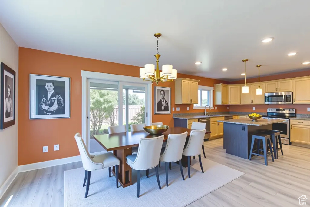 Dining area featuring a chandelier, light wood-style floors, healthy amount of natural light, and recessed lighting