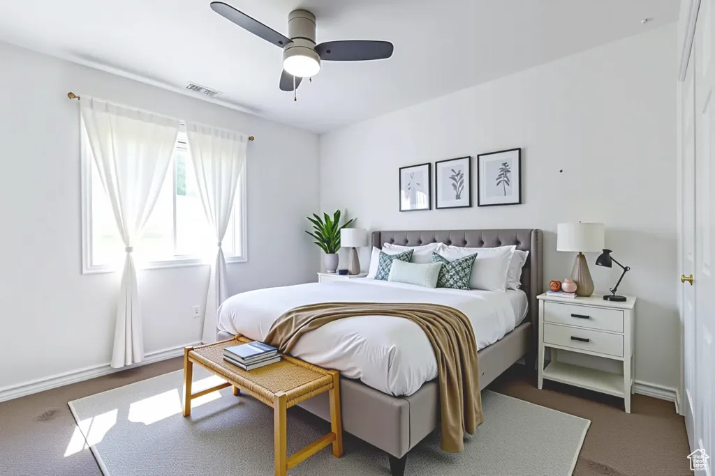 Bedroom with dark colored carpet and a ceiling fan