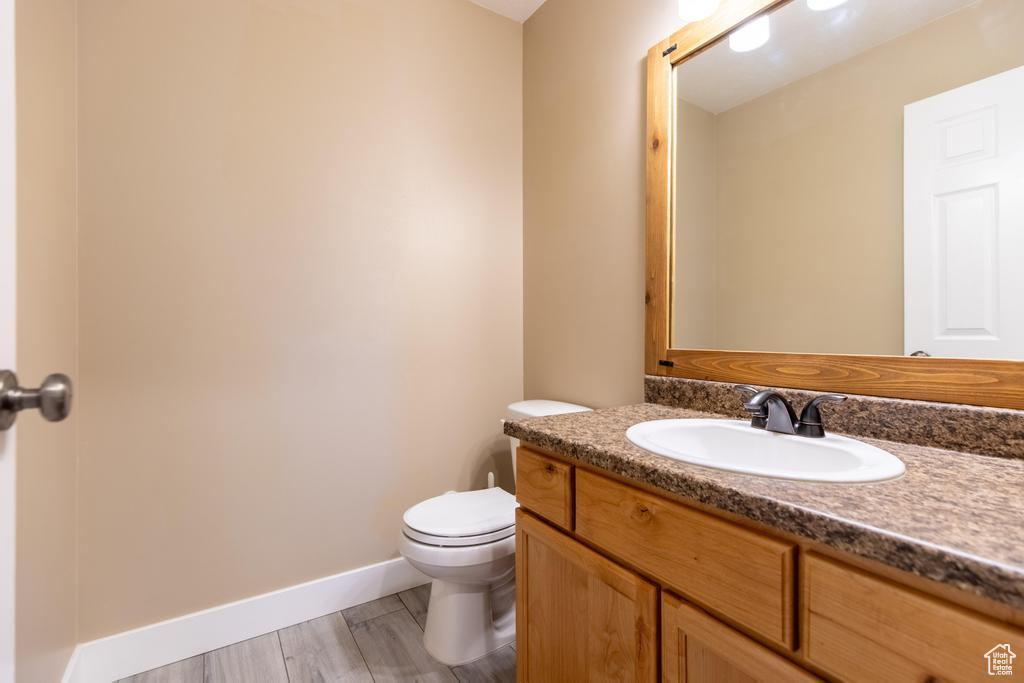 Bathroom featuring vanity and wood finished floors