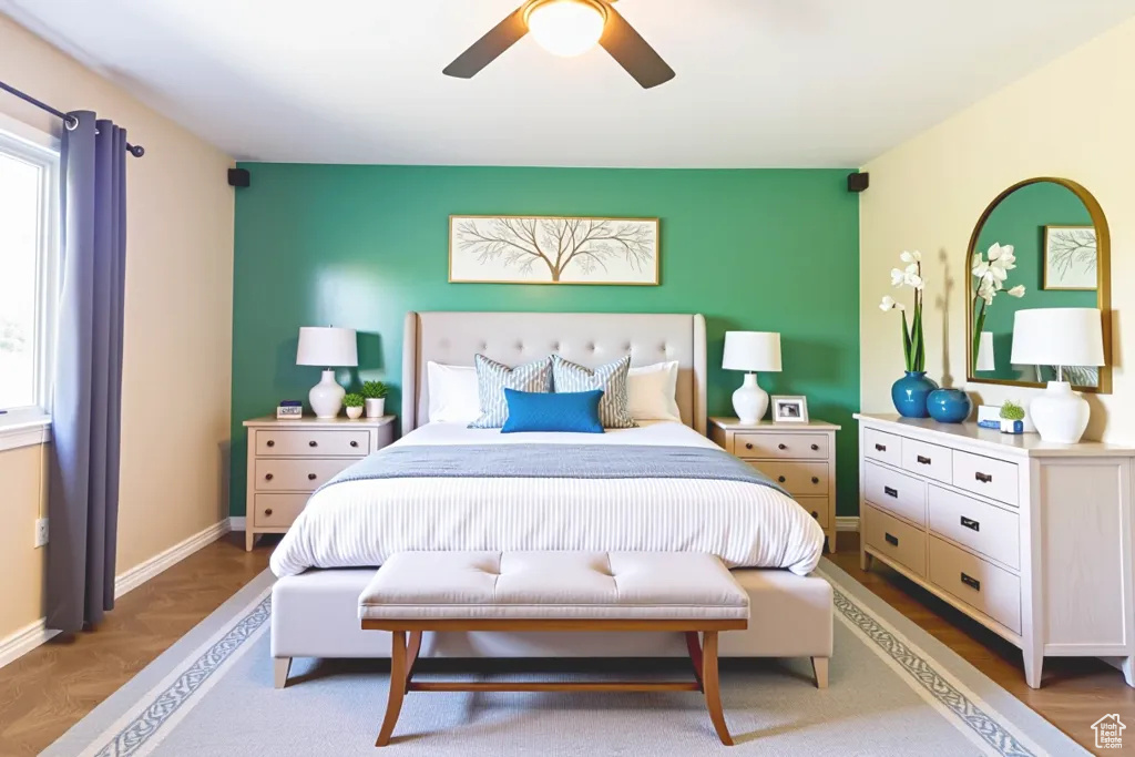 Bedroom with multiple windows, a ceiling fan, and an accent wall