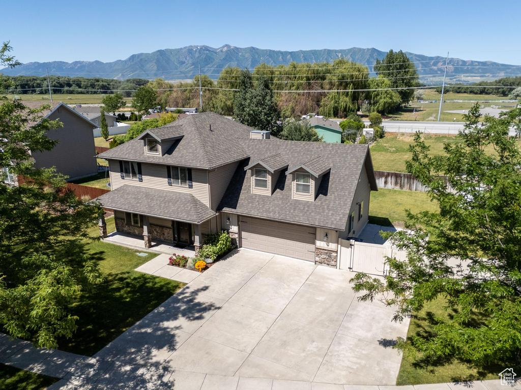 Aerial view of property and surrounding area with a mountainous background