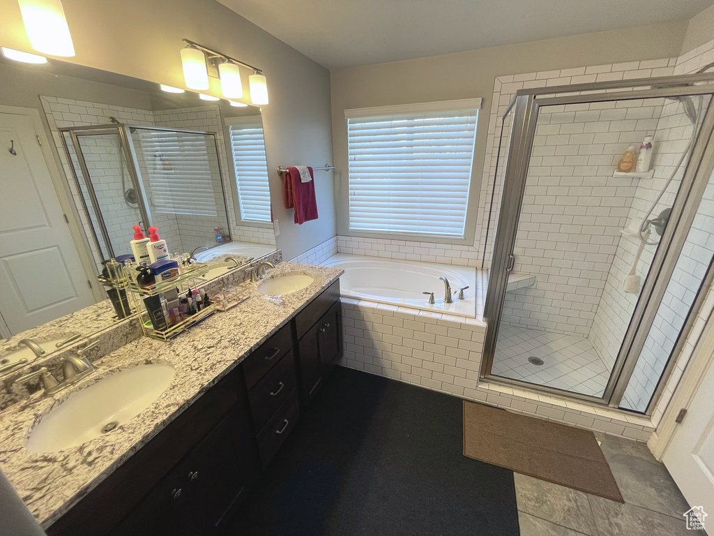 Full bathroom with a garden tub, a stall shower, and double vanity