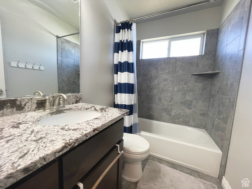 Full bath featuring vanity and shower / bathtub combination with curtain