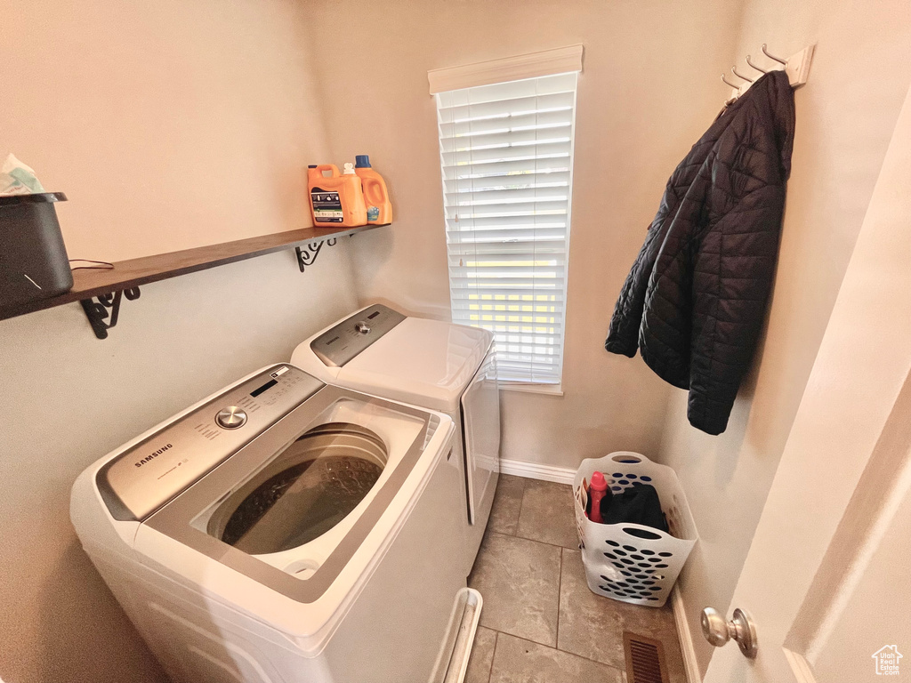 Washroom featuring separate washer and dryer and tile patterned floors