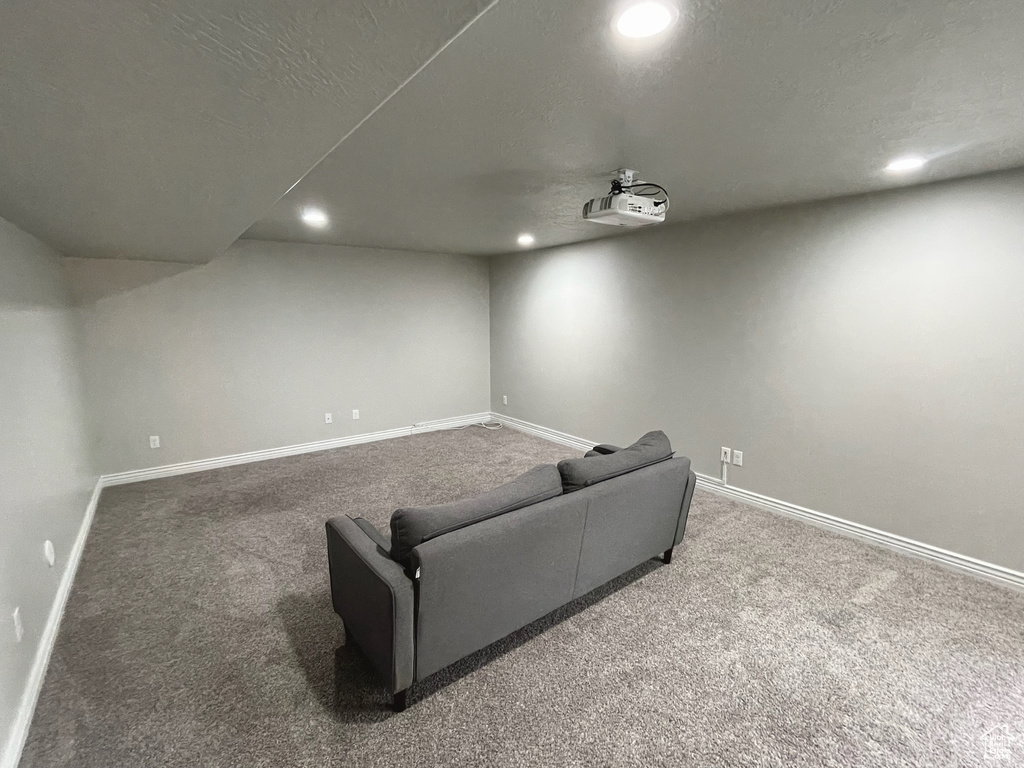 Carpeted home theater featuring recessed lighting and baseboards