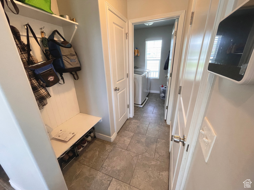 Mudroom featuring separate washer and dryer and baseboards