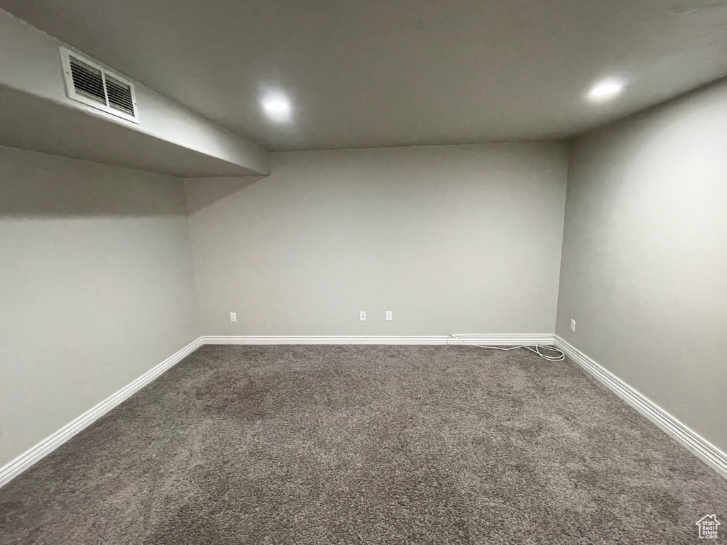 Finished basement featuring dark colored carpet and recessed lighting