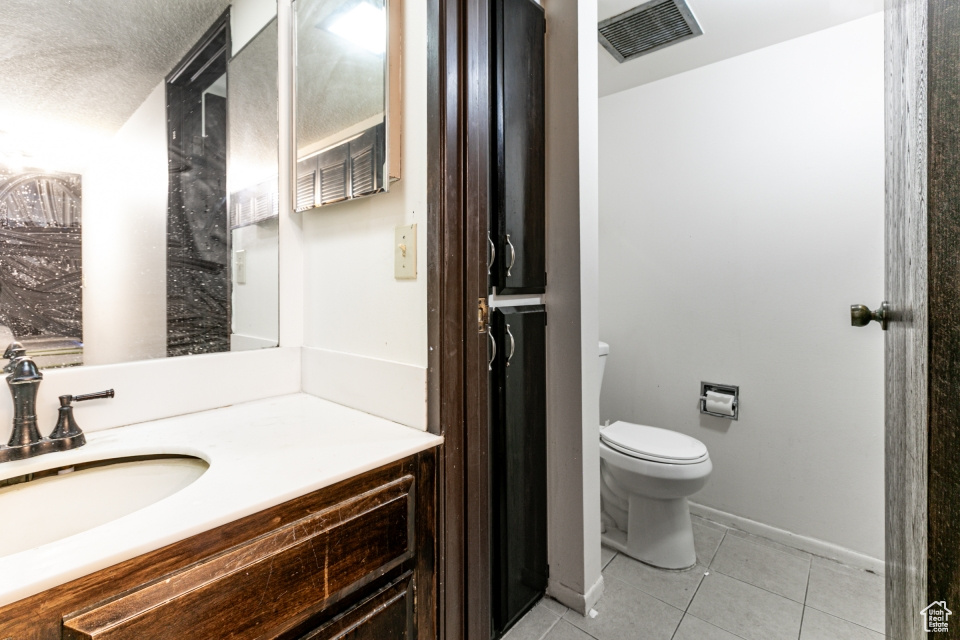 Bathroom with tile patterned flooring and vanity